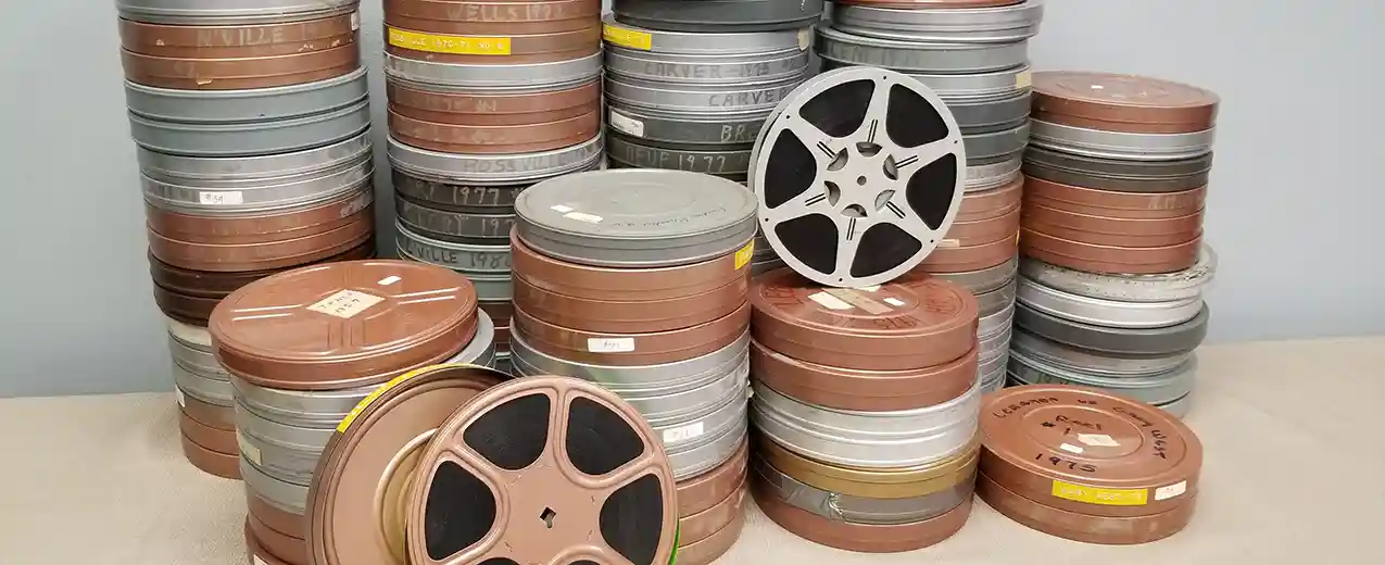 Dozens of reels of 16mm film in cans