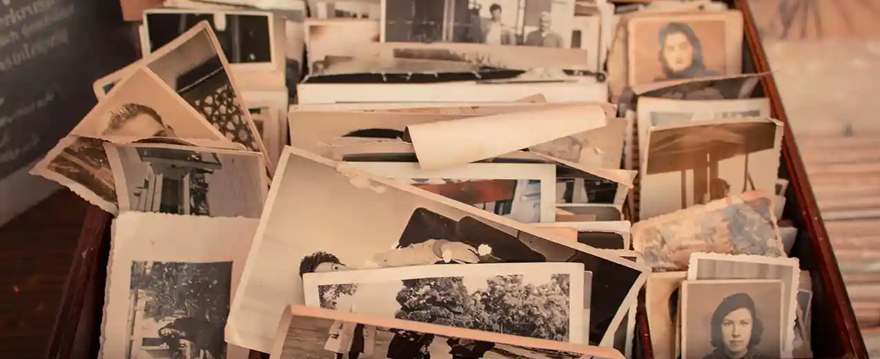 Box of old curled, black and white photos