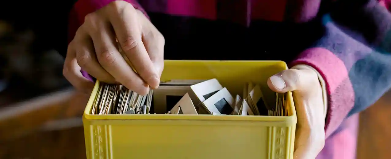 Man holding box of slides